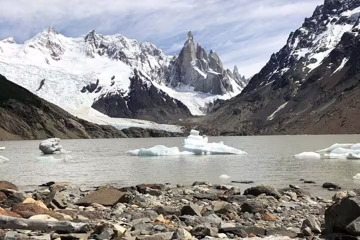 Majestic snow-capped peaks and floating icebergs at Torres del Paine National Park, perfect for a full-day trek.