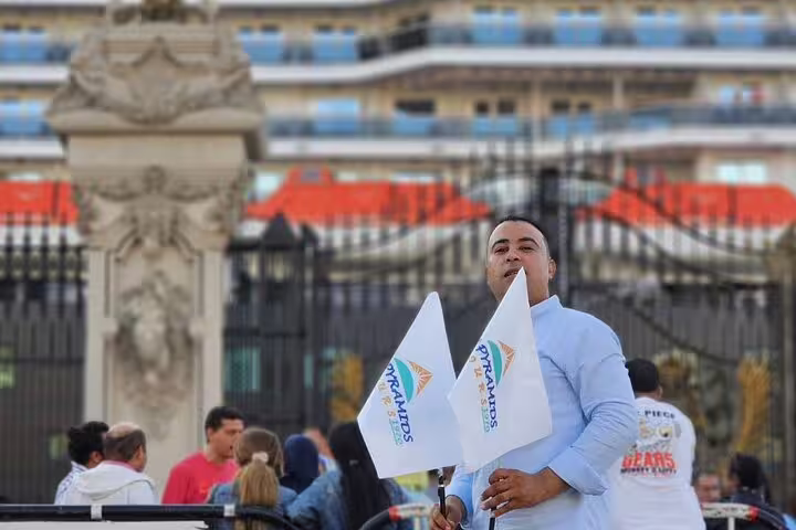 Tour guide holding flags for El Sokhna Port to Giza Pyramids visit and Nile lunch cruise Cairo shore excursion