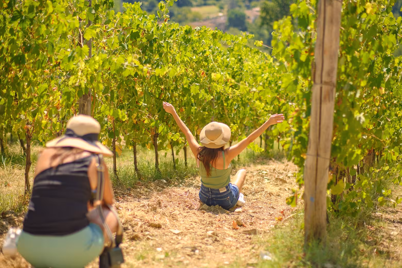 Tourist poses joyfully in Chianti vineyard, capturing memories on a private Florence wine region tour.