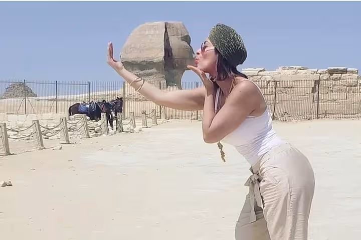 Tourist posing by the Great Sphinx of Giza during a 5 days Cairo and Luxor tour package, Egypt highlights