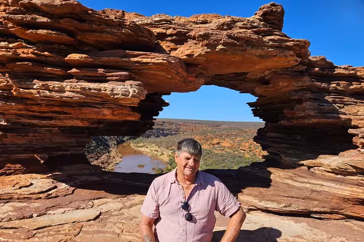 Tourist standing at Natures Window, showcasing the stunning rock formations on the 2-day Pinnacles adventure.