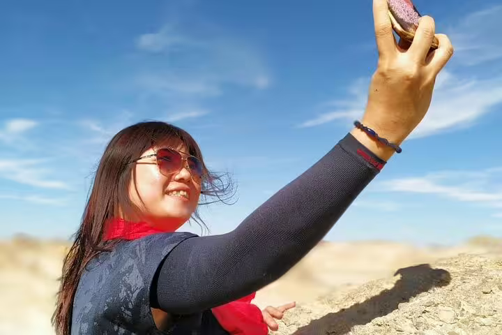Tourist taking a selfie at White Desert National Park, Egypt, during a private day tour from Bahariya Oasis
