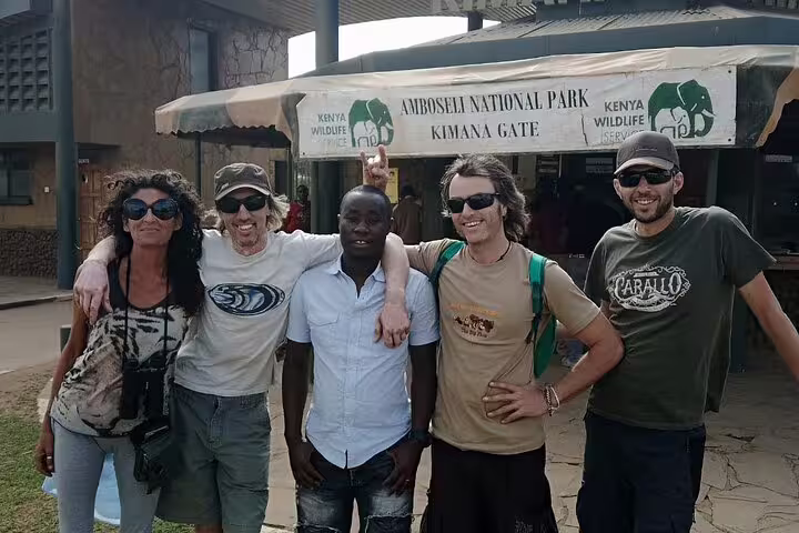 Happy tourists at the entrance of Amboseli National Park, embarking on an exciting 3-day safari from Nairobi.