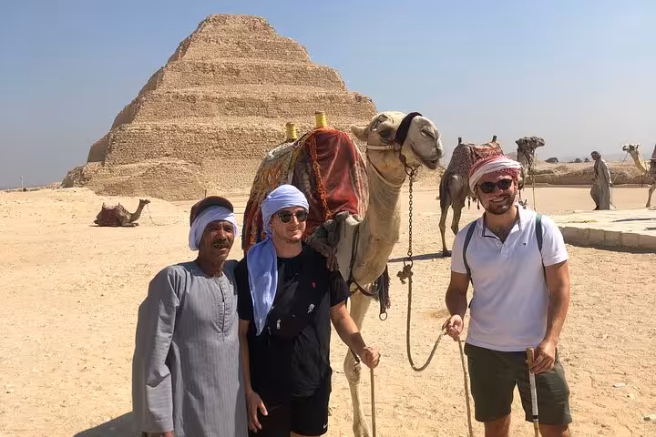 Tourists with camel at Saqqara Step Pyramid, Cairo 3-day all-inclusive pyramids, museums and churches tour
