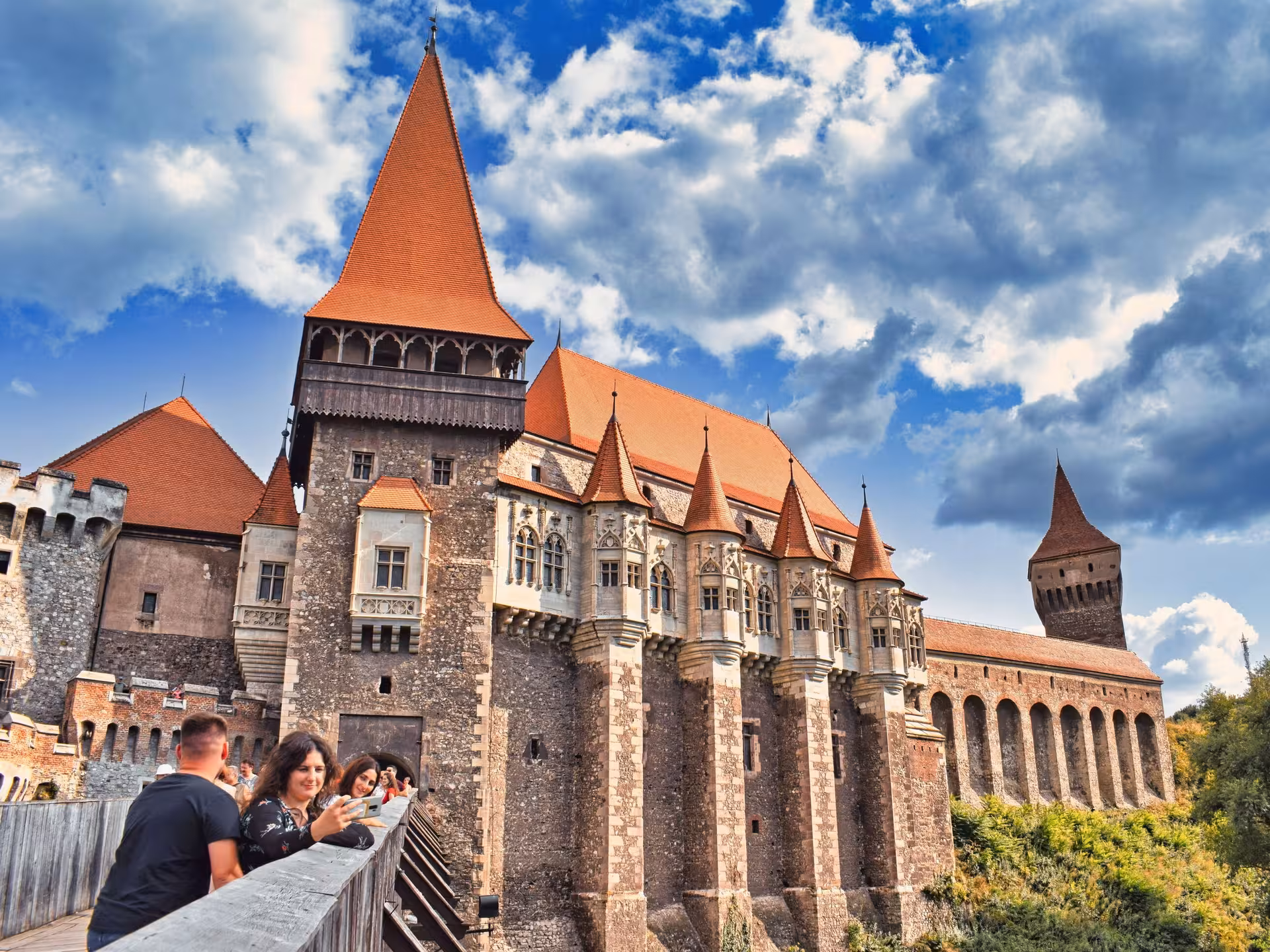 Tourists admiring the stunning Gothic architecture of Corvin Castle on a day trip from Cluj-Napoca Romania
