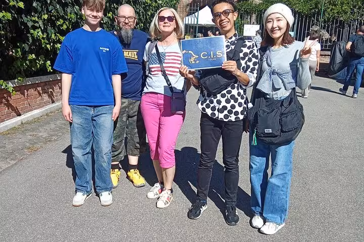 Group of five tourists posing with a C.I.S. sign, excited for the Domus Aurea VR tour in Rome.