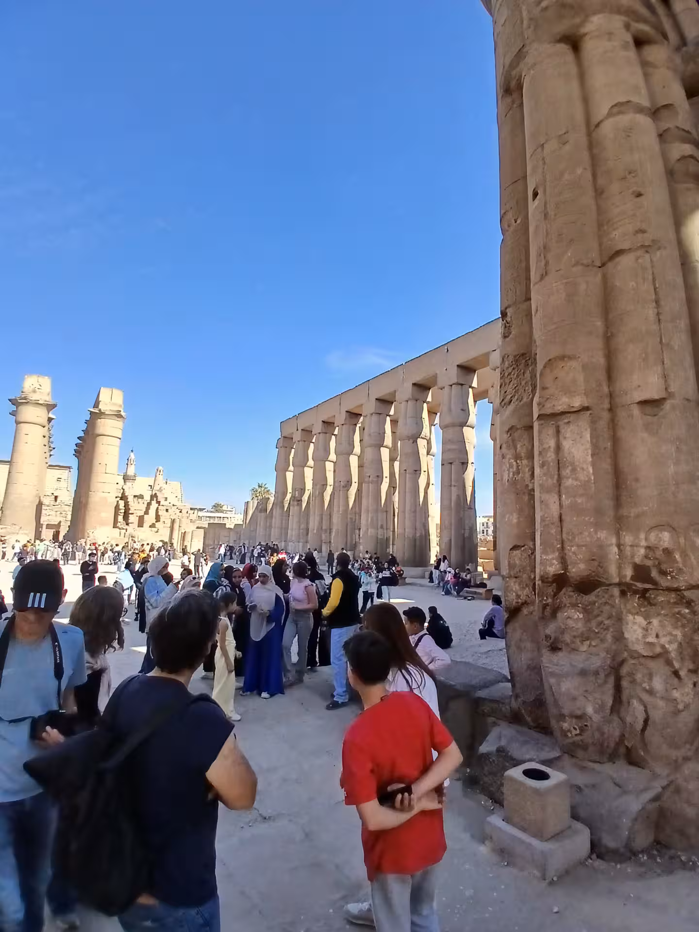 Tourists exploring the iconic Karnak Temple's grand pillars in Luxor, part of the Egypt multi-day trip experience.