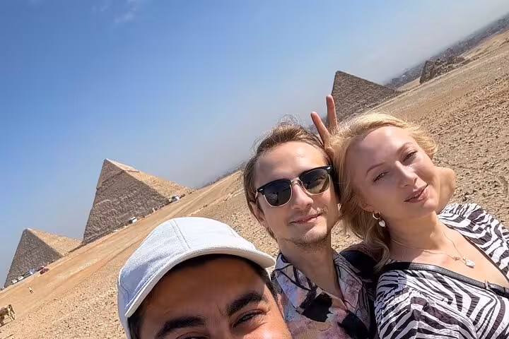 Tourists selfie with Giza Pyramids backdrop on private Cairo tour to Great Sphinx, Saqqara and Memphis