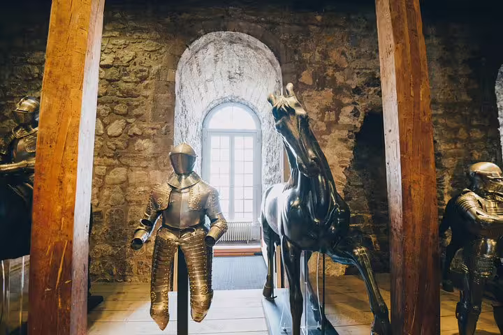 Explore medieval armor and artifacts inside the historic Tower of London on a private skip-the-line tour with lunch included.