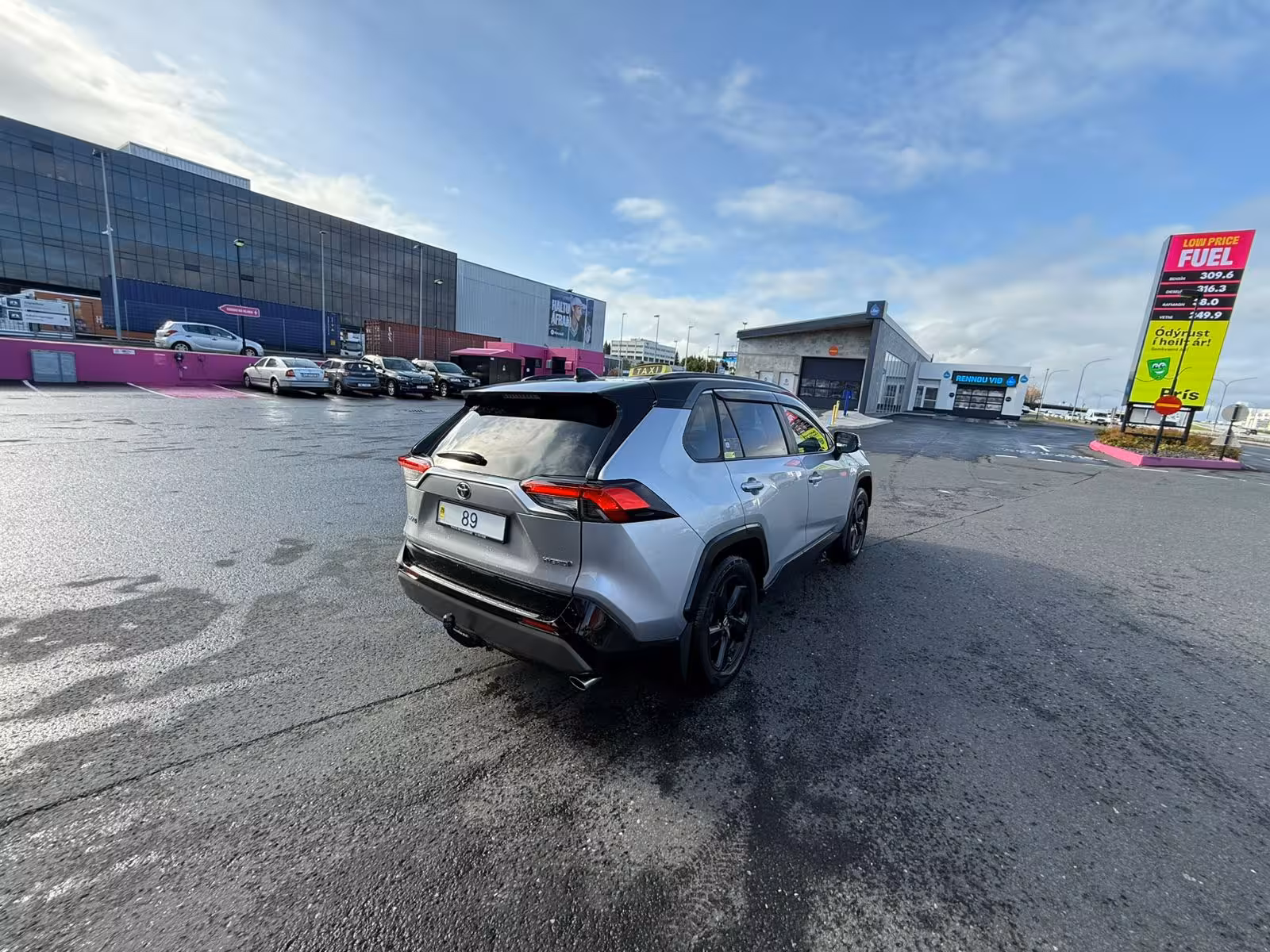 Silver Toyota RAV4 hybrid SUV parked at Reykjavik fuel station near KEF Airport transfer pickup area