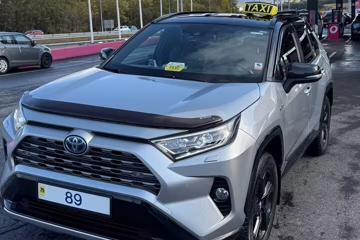 Silver Toyota RAV4 SUV taxi at Keflavik Airport for private transfer to Reykjavik