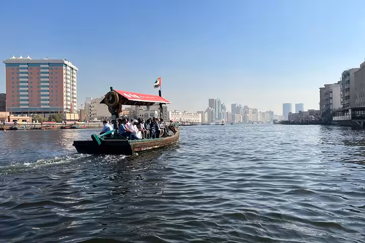 Traditional abra boat crossing Dubai Creek near Deira and Bur Dubai on Old Dubai historic walking tour