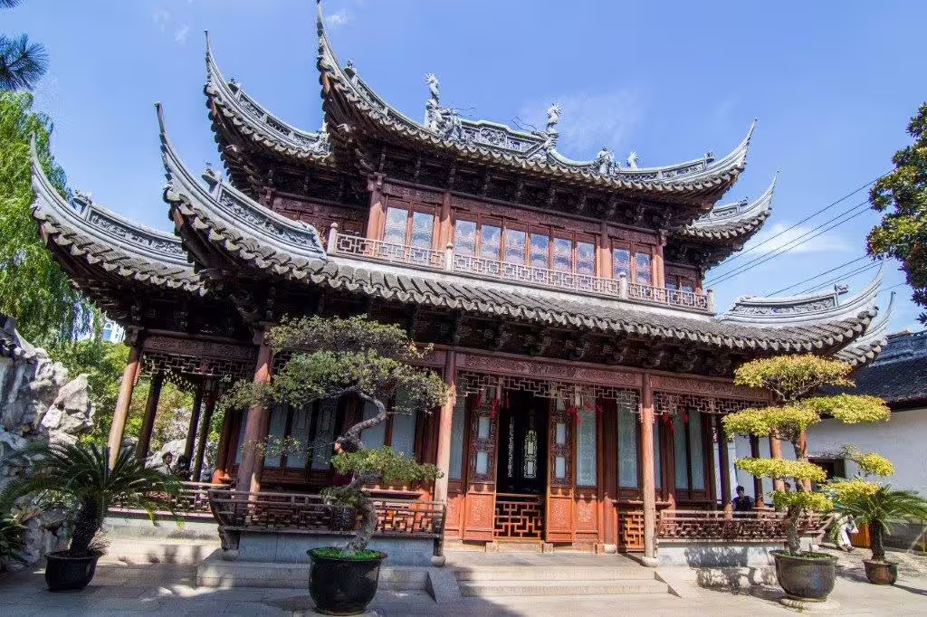 Exquisite traditional Chinese pagoda with ornate roof detailing, a cultural landmark on the Shanghai to Laos tour.