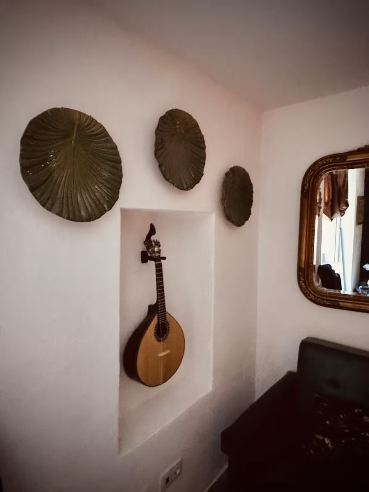 Traditional Portuguese guitar displayed on a wall, highlighting the cultural significance in Fado music venues.