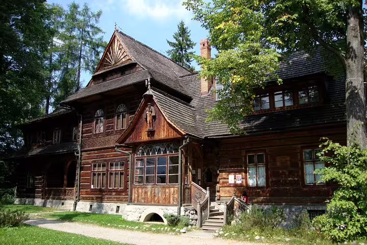 Traditional wooden villa in Zakopane surrounded by trees, a scenic stop on a private day trip from Krakow