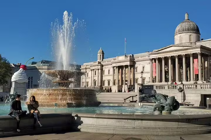 Trafalgar Square fountain with National Gallery and giant cupcake sculpture, London