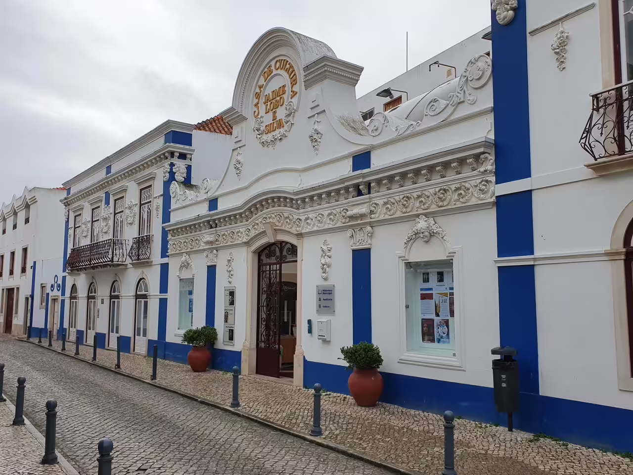 Charming street view of a historic building in Ericeira, Portugal, showcasing intricate architectural details and vibrant colors.