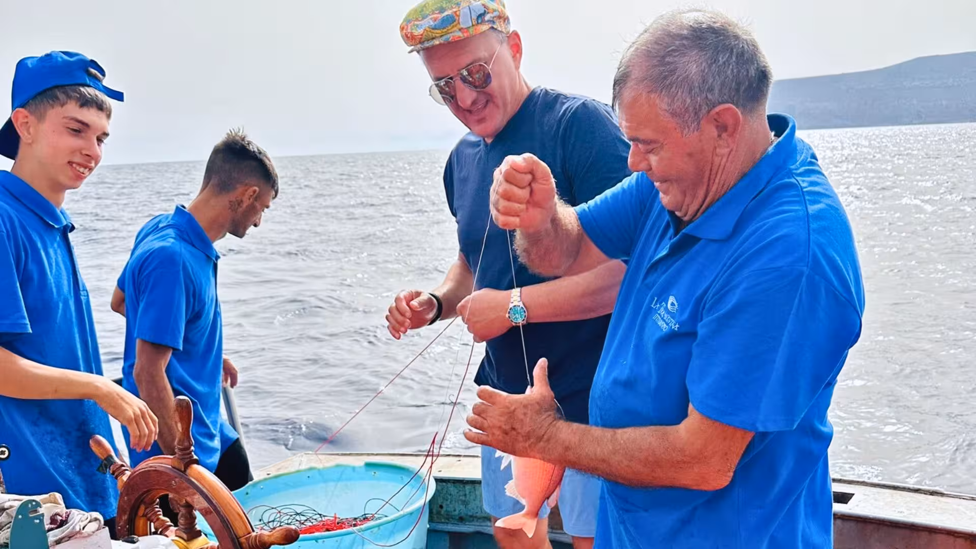Tourists enjoy hands-on fishing experience with locals in the scenic Egadi Islands near Trapani, Italy.