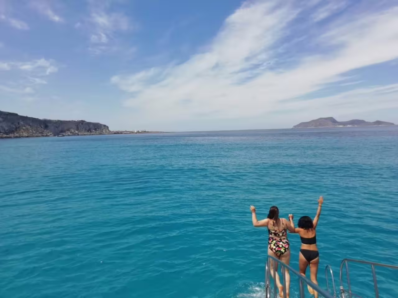 Guests jump into turquoise sea on Trapani mini-cruise to Favignana and Levanzo, Egadi Islands swim stop