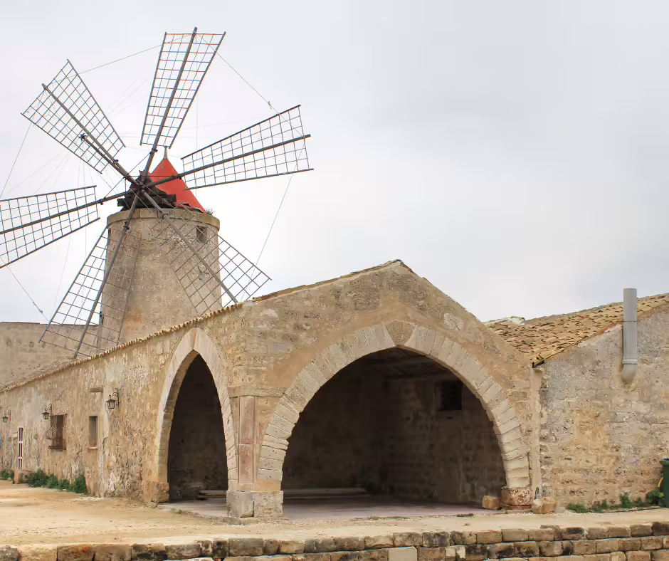 Close-up of a traditional stone windmill at the Trapani salt pans, a highlight of private tours from Palermo