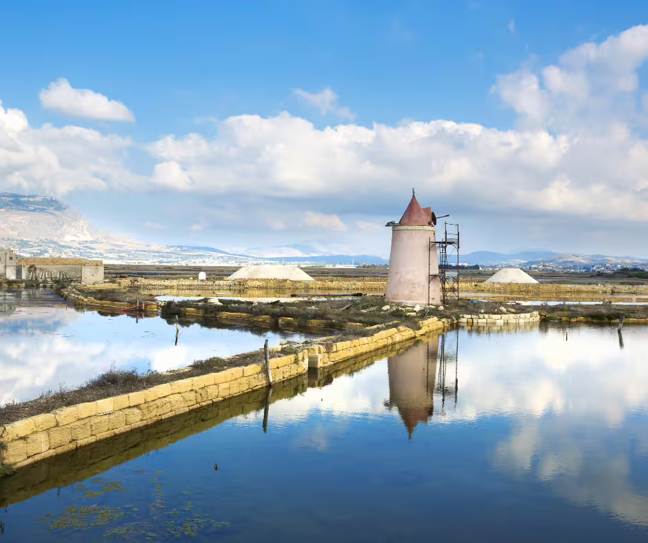 Traditional windmill reflected in the Trapani salt pans near Marsala on a private Segesta, Erice and Trapani tour from Palermo