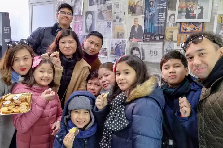Family group enjoying traditional Roman street food snacks on a Trastevere walking food tour in Rome