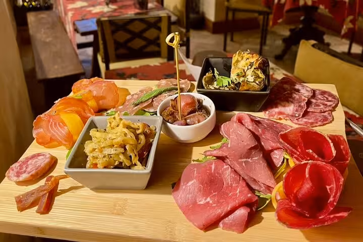 Artisanal Italian charcuterie board with cured meats, bruschetta and seasonal antipasti on a Trastevere food and wine tasting