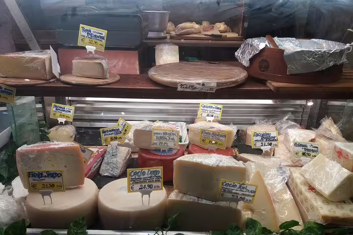 Artisan Italian cheese display with price tags at a local Trastevere market during a Rome food tour