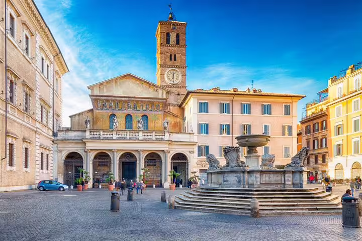 Piazza di Santa Maria in Trastevere with baroque fountain and medieval church bell tower, Rome