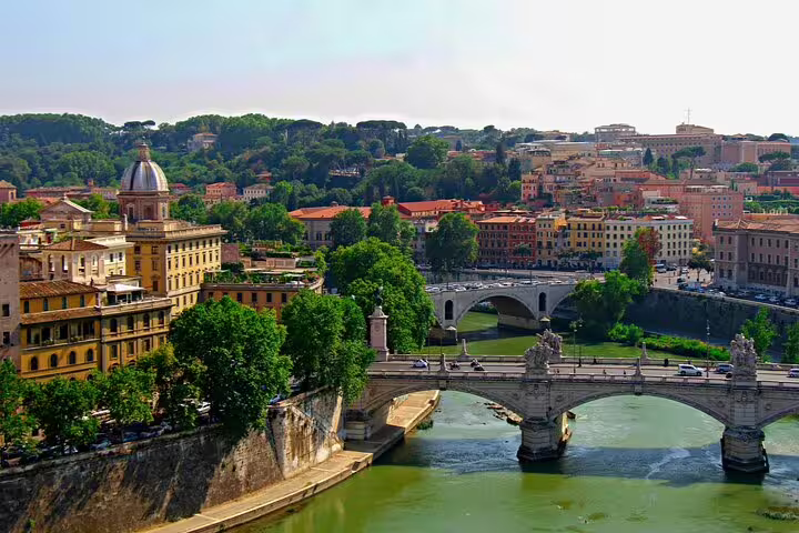 Aerial view of Tiber River bridges and colorful historic buildings in Trastevere, Rome