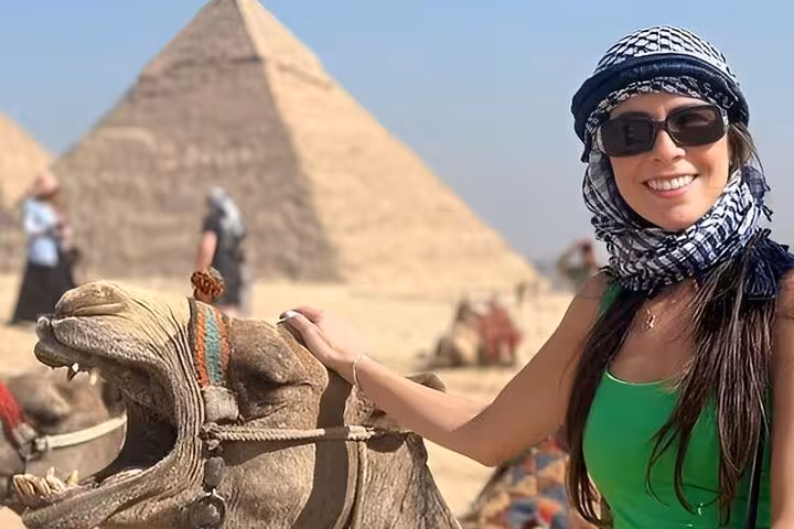 Traveler with camel at the Great Pyramid of Giza, Egypt, on a Giza Pyramids Saqqara Memphis day tour