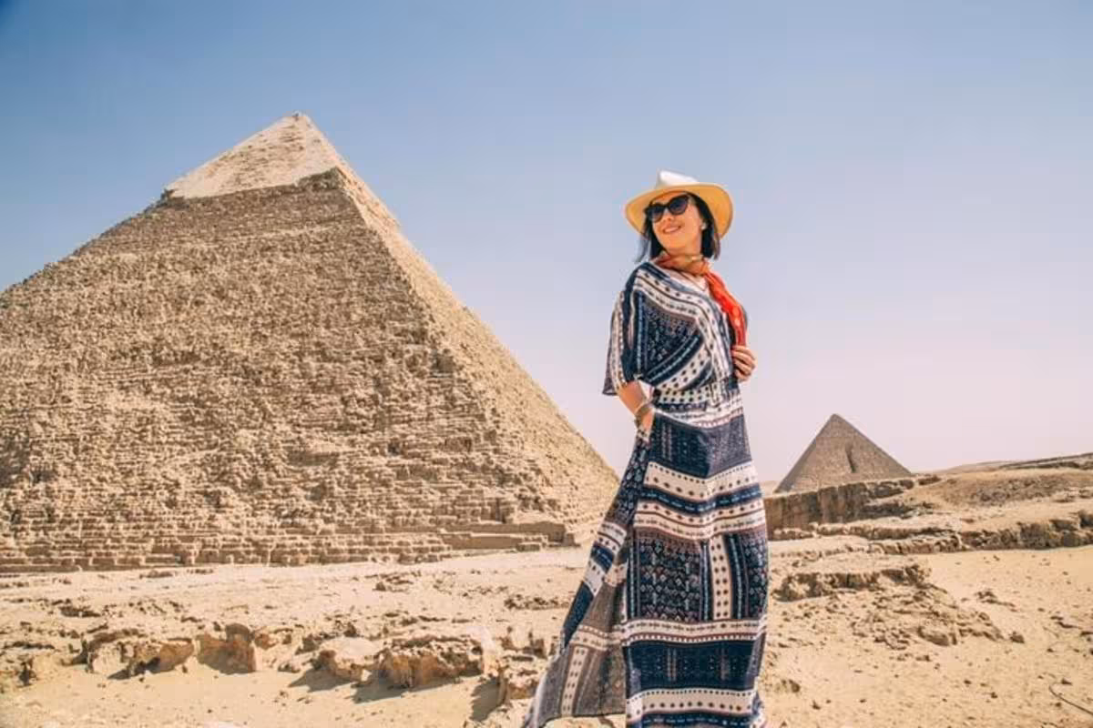 Traveler in sunhat at the Great Pyramid of Giza, Cairo, on a camel ride and lunch tour in Egypt
