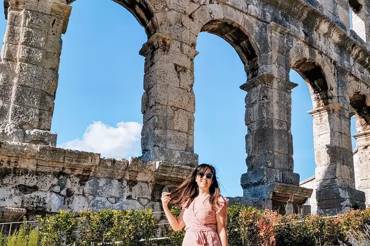 Traveler by Colosseum arches in Rome, perfect for a self-guided Colosseum, Palatine Hill and Roman Forum visit