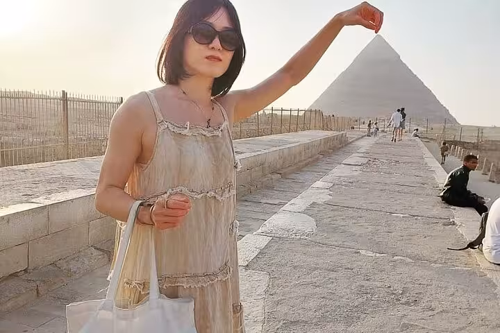 Traveler posing at Giza Pyramid viewpoint on Hurghada to Cairo day tour to Pyramids and Grand Egyptian Museum