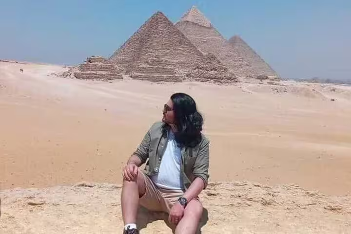 Traveler at Giza Pyramids on overnight Cairo tour from Alexandria Port, classic Egypt sightseeing experience