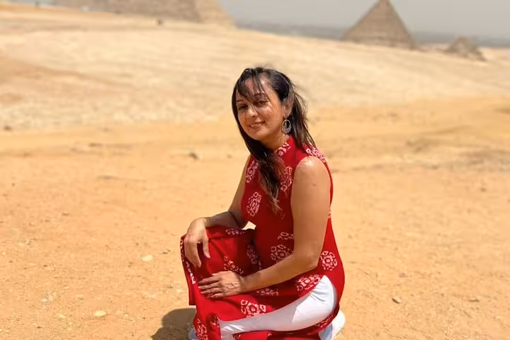 Traveler in desert with Giza Pyramid in background on private Giza Pyramids and Sphinx guided tour