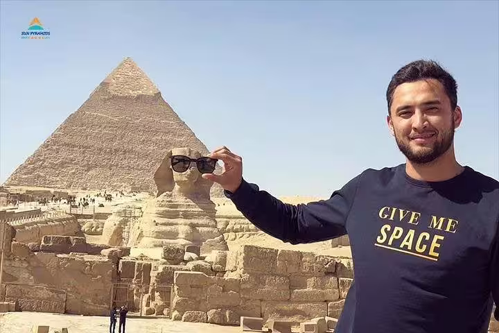 Traveler at Giza Sphinx and Great Pyramid, highlight of private Cairo day trip from Dahab by flight