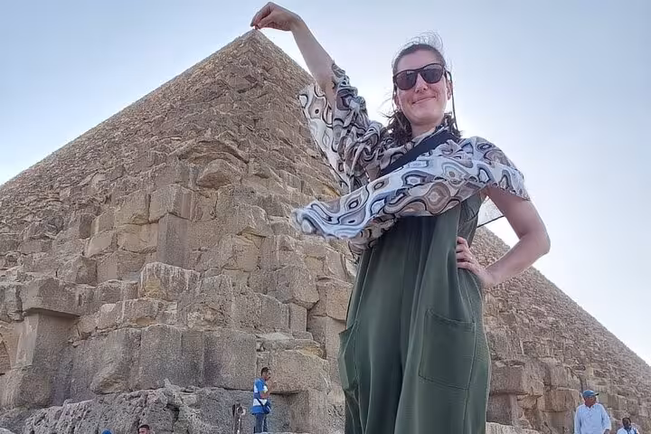 Traveler posing at the Great Pyramid of Giza on a Cairo private tour with Grand Egyptian Museum visit