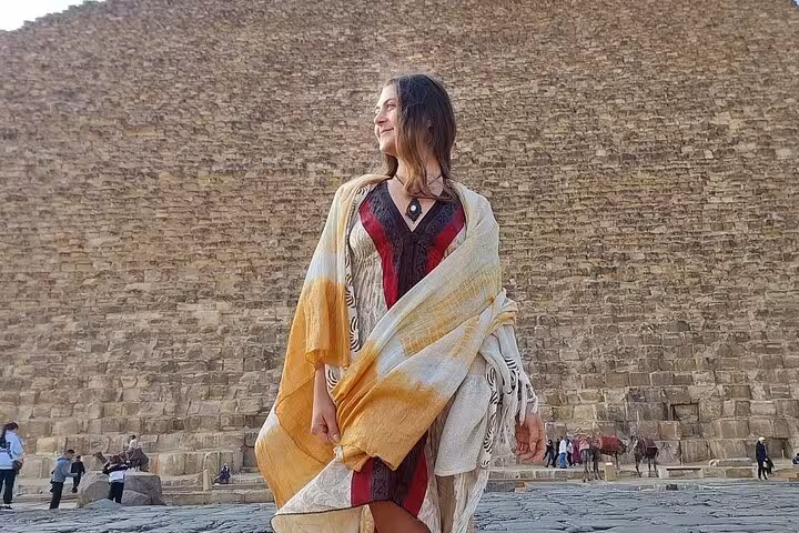 Traveler posing by the Great Pyramid of Giza on a private 3-day Cairo Alexandria tour with local food stops
