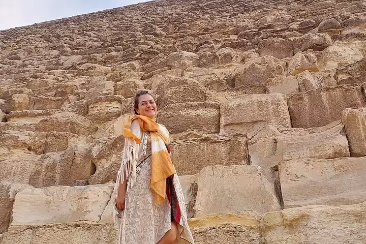 Traveler beside massive stone blocks at the Great Pyramid of Giza on a Cairo 2-day tour in Egypt