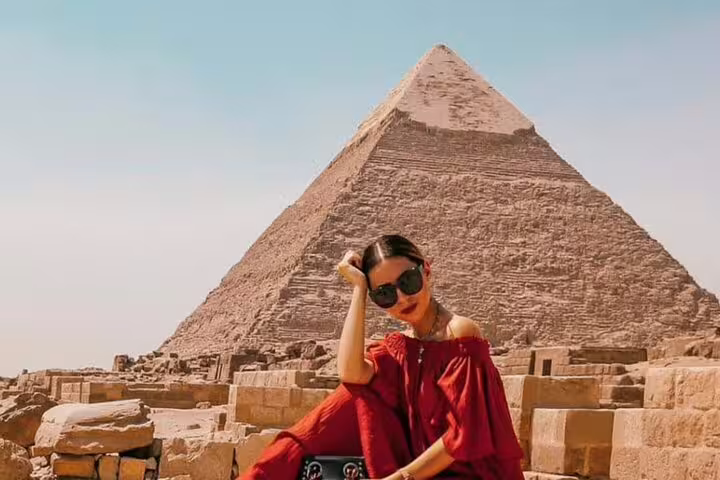 Traveler posing by the Great Pyramid of Giza on a private Port Said shore excursion tour to Cairo