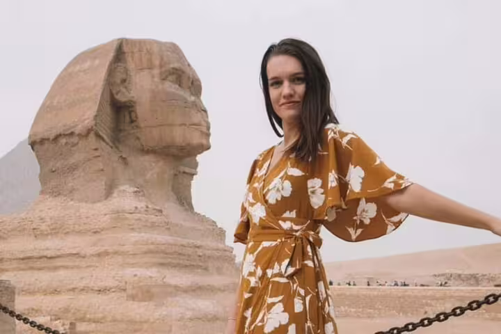Traveler posing by the Great Sphinx of Giza during a Cairo 3-day highlights tour with pyramids backdrop