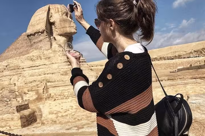 Traveler photographing the Great Sphinx of Giza on a 5 days Cairo and Luxor tour package in Egypt