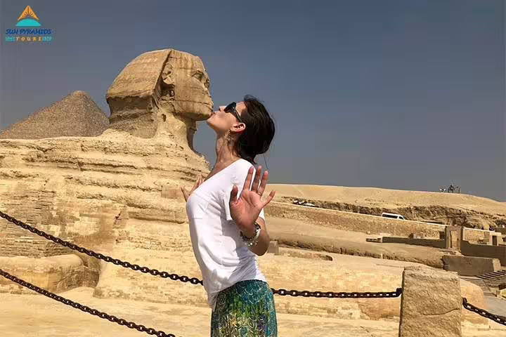 Traveler posing near the Great Sphinx at Giza on Cairo tour visiting pyramids, Memphis, Saqqara, Dahshur and Cairo Tower