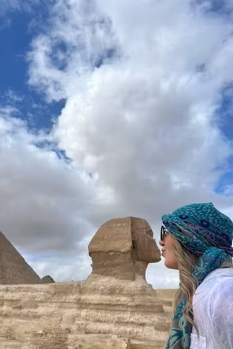 Traveler beside the Great Sphinx at Giza under blue sky, VIP Giza Pyramids and Grand Egyptian Museum tour
