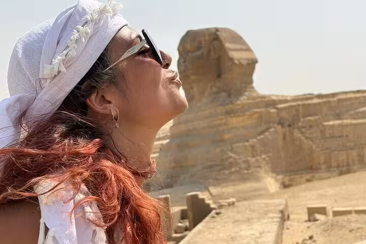 Traveler posing by the Great Sphinx at Giza on VIP tour, Pyramids and Sphinx stop with camel ride and Felucca
