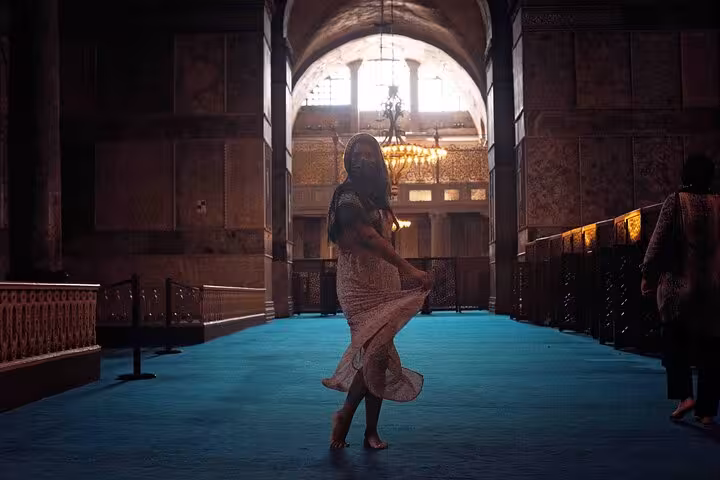 Traveler walking inside Hagia Sophia on blue carpet, part of an all-inclusive private guided 3-day Istanbul tour