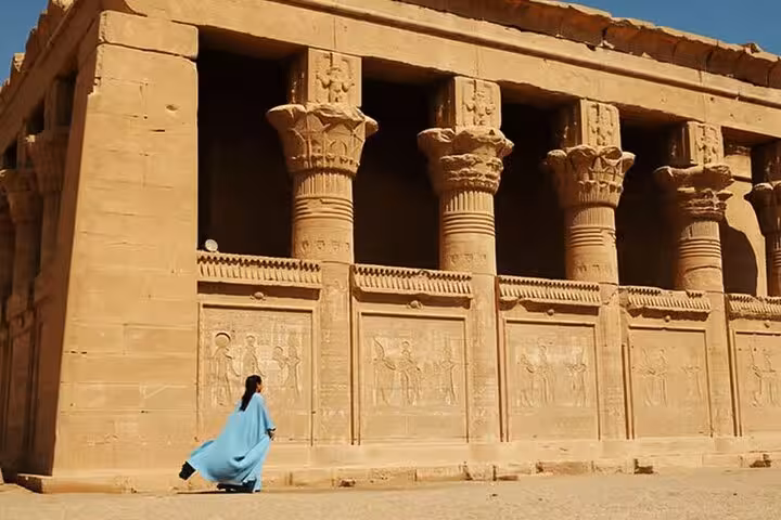Traveler by Hathor-column facade at Dendera Temple, part of Luxor day tour to Dendera and Abydos temples