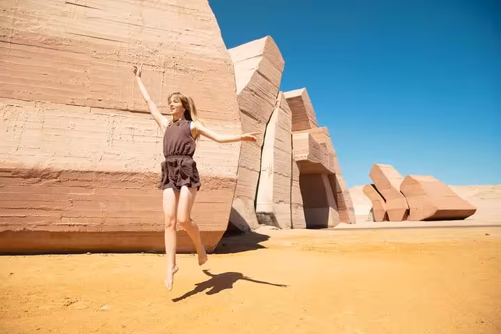 Traveler jumping by desert rock formations on Ras Mohamed half-day tour from Sharm El-Sheikh, Sinai