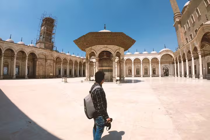 Traveler exploring Mosque of Muhammad Ali courtyard at Cairo Citadel, on guided National Museum and bazaars tour